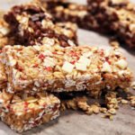 Granola bar. Healthy sweet dessert snack. Cereal granola bar with nuts, fruit and berries