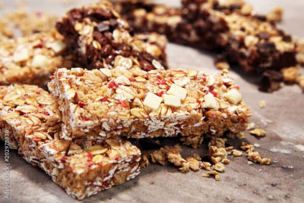 Granola bar. Healthy sweet dessert snack. Cereal granola bar with nuts, fruit and berries