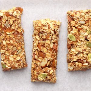 Homemade granola bars on white baking paper.