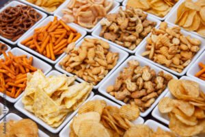 Many types of savoury snack in white dishes