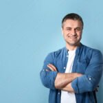 Portrait of handsome mature man on color background