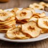 Stacked apple chips with cinnamon sticks and honey a delicious autumn treat on transparent background